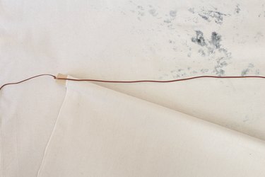 Thread leather through eye hook