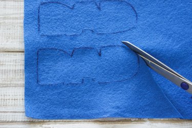 "DAD" design being cut out with scissors.
