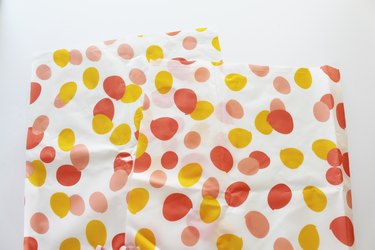 Cut the tablecloth into strips.
