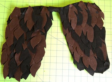 Completed wings covered in brown felt feathers.