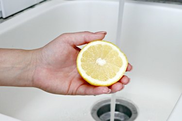 Hand holding a cut lemon
