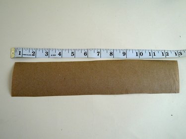 Strip of brown paper and a ruler.
