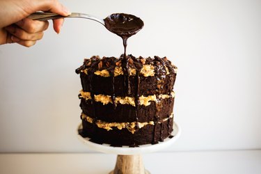 Drizzling the cake with chocolate espresso sauce.
