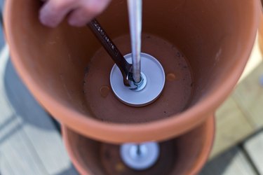 Secure pot by tightening nut.