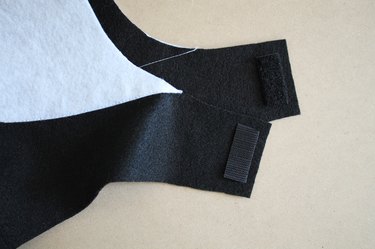 Sew hook-and-loop tape onto the chin straps to secure the hood.