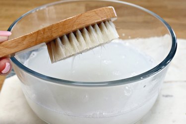 Scrub brush and bowl of cleaning solution