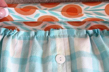 Tuck gathered section of apron into waistband