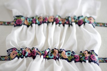 Instead of just hanging your towel over a cupboard door or throwing it on the counter, add a little ribbon to the top so you can give it a place of honor in your kitchen and hang it from your oven door.