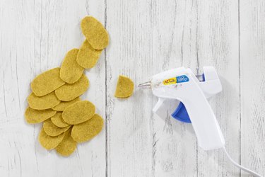 Gluing yellow felt ovals for DIY felt succulent plant