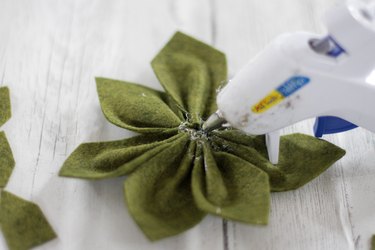 Gluing the star-shaped green felt