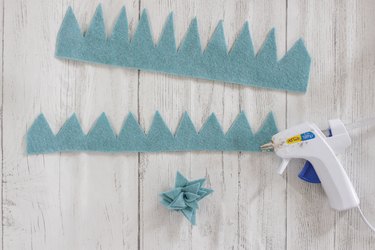 Continuing to glue and coil blue felt for DIY felt succulent plant
