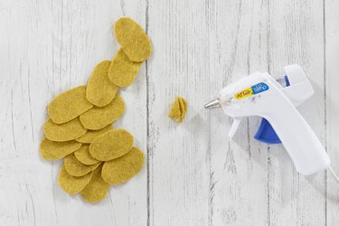 Gluing yellow felt ovals for DIY felt succulent plant