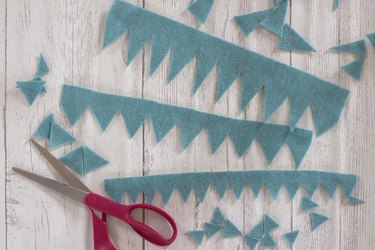 Cutting spikes into pieces of blue felt
