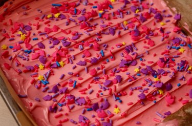 Finished sugar cookie bar with pink frosting and sprinkles.