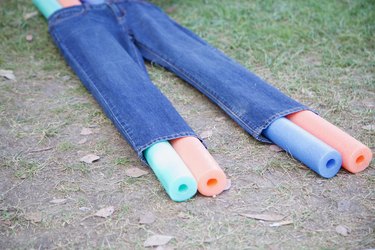 pool noodles inside jeans legs