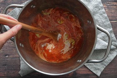 Stirring a pot of creamy tortellini soup