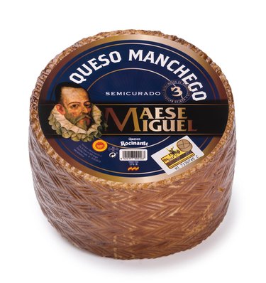 A one-pound mini-wheel of Maese Miguel Manchego cheese, on a white ground