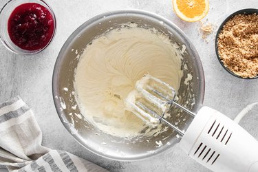 Mixing cheesecake filling with electric beater