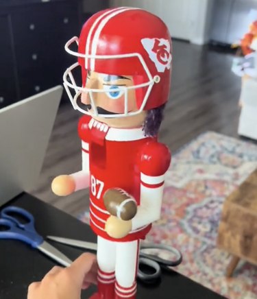 Red nutcracker in a red and white football helmet