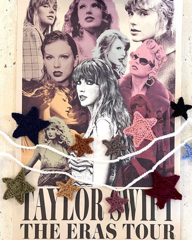 Colorful crochet garland atop Eras Tour poster