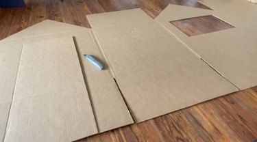 Open box with cutout door, window and roof lines