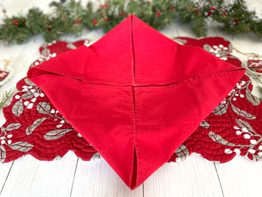 Fold corners into the center of the napkin