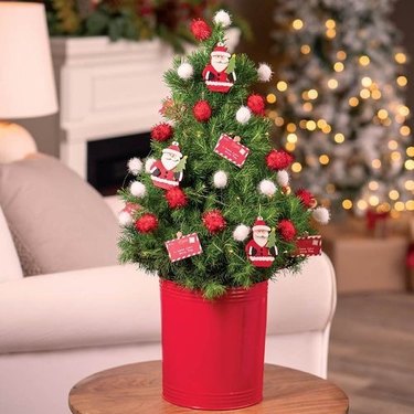 This Candy Wonderland tree is a 2-foot Alberta Spruce that's decked to the max in holiday decorations and lights.
