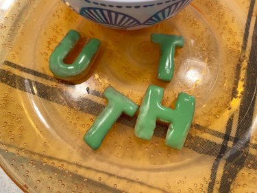 Alphabet cookies with royal icing on plate