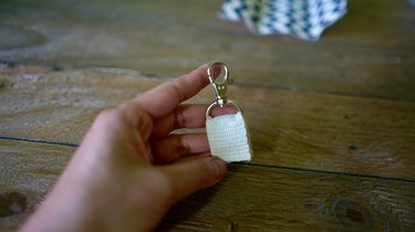 Cotton belting inserted into D-ring with lobster clasp