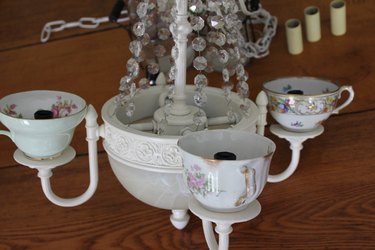 Place the teacups over the electrical sockets.