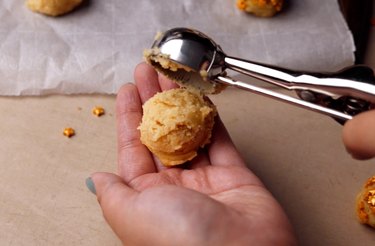 Scooping cookie dough into hand