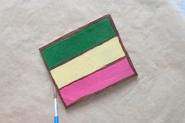 Add brown paint to edges of clay coaster