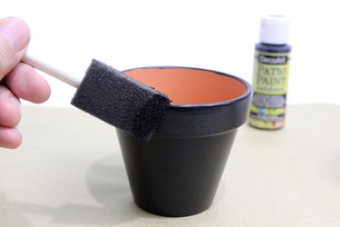 painting smallest pot with black paint