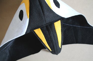 Adjust the beak until it's centered and sew it to the hood.