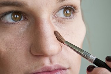 a closeup of a woman contouring her nose