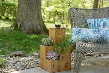 Four tiered table planter next to a bench
