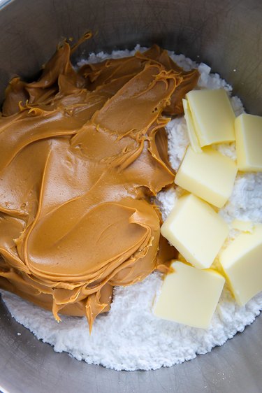 In a large bowl combine the peanut butter, sugar, butter, and vanilla.