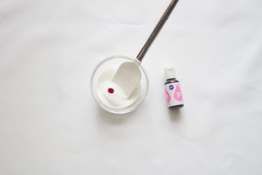 Drop food coloring in sugar