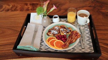 breakfast tray with stuffed french toast, bacon, and orange slices