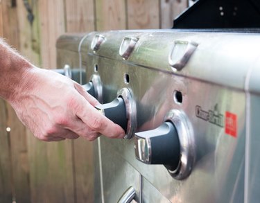 Turning up the temperature knobs on a gas grill