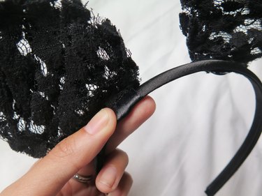 Pressing the ribbon onto the top of the headband.