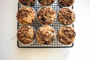 Perfectly golden muffins set to cool on a baking tray.