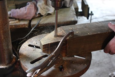 Drill a hole through the top of the wood
