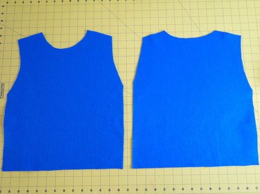 Two vest shaped pieces of blue felt.