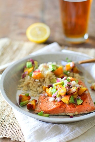 Grilled salmon covered with peach salsa.