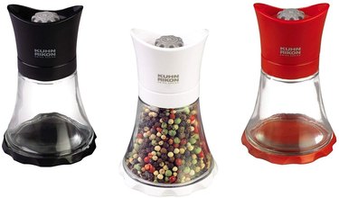 Kuhn Rikon pepper grinders in black, white and red on a white ground