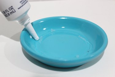 Adding glue to saucer