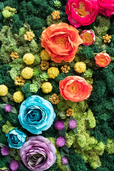 Moss wall art with faux flowers