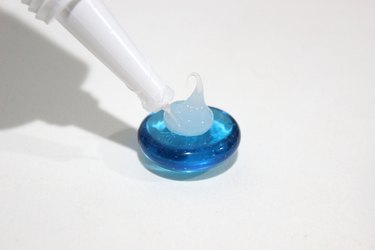 Adding glue to a blue glass bead