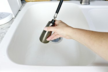 Rinsing water in white kitchen sink